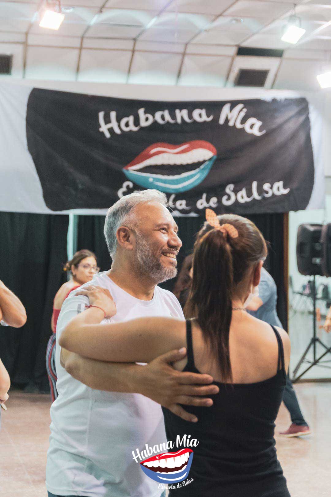 Pareja sonriendo mientras baila en Habana Mía
